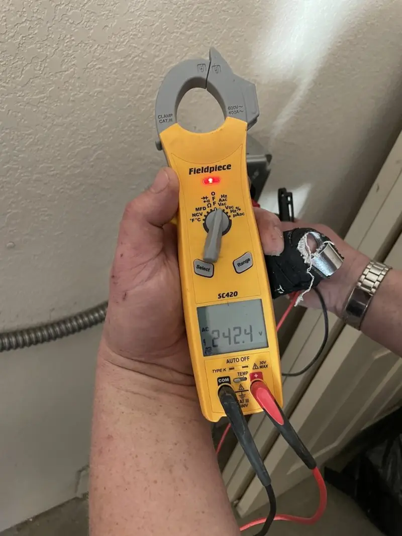 Voltage testing with clamp meter during Ceiling Fan Installation in Oregon